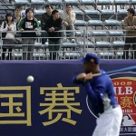 Chinese spectators watch the Los Angeles Dodgers work out Friday, March 14, 2008, in Beijing, China. The Dodgers will play the San Diego Padres in an exhibition series this weekend. (AP Photo/Robert F. Bukaty)