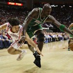 Boston Celtics' Kevin Garnett (5) and Houston Rockets' Luis Scola, left, of Argentina, reach for a loose ball during the first quarter of a basketball game Tuesday, March 18, 2008, in Houston. (AP Photo/David J. Phillip)