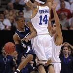 Xavier's Stanley Burrell, left, passes around UCLA's Lorenzo Mata-Real (14) during the second half of their NCAA men's basketball tournament West Regional final, Saturday, March 29, 2008, in Phoenix. (AP Photo/Mark J. Terrill)