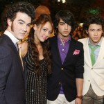 Jonas Brothers and Miley Ray Cyrus are seen before the start of the 21st Annual Kids' Choice Awards in Los Angeles, on Saturday, March 29, 2008. (AP Photo/Matt Sayles)
