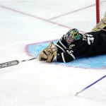 Dallas Stars goalie Marty Turco, top, lunges to hit the puck during first-period action against the Phoenix Coyotes during an NHL hockey game Friday, April 4, 2008, in Dallas. (AP Photo/Tim Sharp)