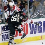 Dallas Stars center Joel Lundqvist (39) pushes Phoenix Coyotes defender Ed Jovanovski (55) against the glass in the first period of an NHL hockey game Friday, April 4, 2008, in Dallas. (AP Photo/Tim Sharp)