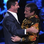 Robin Williams, right, and Simon Cowell are seen on stage at the "Idol Gives Back" fundraising special of "American Idol" in Los Angeles on Sunday April 6, 2008. (AP Photo/Mark J. Terrill)