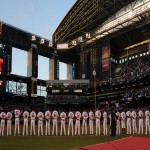 Members from the Arizona Diamondbacks line up along the third base line for the National Athem prior to the start of Arizona's home opener against the Los Angeles Dodgers on Monday at Chase Field. Samantha Hjelle For Sports 620 KTAR
