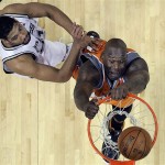 Phoenix Suns center Shaquille O'Neal, right, scores as San Antonio Spurs forward Tim Duncan, left, defends during the first quarter in Game 1 of an NBA Western Conference playoff basketball series in San Antonio, Saturday, April 19, 2009. (AP Photo/Eric Gay)