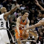 Phoenix Suns guard Steve Nash (13) is defended by San Antonio Spurs forward Bruce Bowen (12) and forward Tim Duncan, right, during the first quarter of Game 1 of an NBA basketball playoffs first-round series Saturday, April 19, 2008, in San Antonio. (AP Photo/Eric Gay)