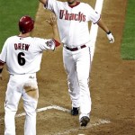 Arizona Diamondbacks pitcher Micah Owings high-fives teammate Stephen Drew after hitting a pinch-hit two-run home run against the Houston Astros during the sixth inning of a baseball game Wednesday, April 30, 2008, in Phoenix. (AP Photo/Matt York)