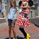 In this image released by Disney, Miley Cyrus from the Disney Channel's "Hannah Montana" poses with Disney character Minnie Mouse at the Magic Kingdom at Walt Disney World Resort in Lake Buena Vista, Fla., on Thursday, May 1, 2008. Cyrus was in town to promote the "Disney Channel Games," a made-for-television, Olympic-style competition that will air this summer on the Disney Channel. (AP Photo/Disney, Garth Vaughan)