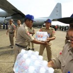 Myanmar soldiers unload drinking water from a Thai transport plane at Yangon airport in Myanmar Tuesday, May 6, 2008. Myanmar's Irrawaddy delta, where nearly 22,000 people perished, remained largely cut off from the rest of the world Tuesday, four days after a cyclone unleashed winds, floods and high tidal waves on the densely populated region. (AP Photo)
