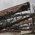 A man stands at the broken pier following devastating cyclone in Yangon, Wednesday, May 7, 2008. International aid began trickling into military-ruled Myanmar, but much of the Irrawaddy delta, where most of the 22,464 reported victims perished, has remained cut off since Cyclone Nargis hit early Saturday. (AP Photo)
