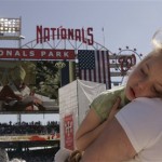 Felicity Robertson, 4, of Damascus, Md., sleeps as she is held by her mother Mary Robertson, Thursday, April 17, 2008, as Pope Benedict XVI celebrates Mass at Washington Nationals baseball Park in Washington. (AP Photo/Susan Walsh)
