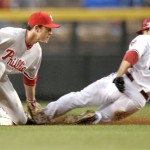 Philadelphia Phillies' Chase Utley, left, tags out Arizona Diamondbacks Jeff Salazar (12) on a steal attempt during the first inning of a baseball game Wednesday, May 7, 2008 in Phoenix. (AP Photo/Matt York)
