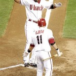 Arizona Diamondbacks' Chris Young, left, touches home plate after hitting a solo home run against the Philadelphia Philllies during the fifth inning of a baseball game Wednesday, May 7, 2008 in Phoenix. Congratulating Young is teammate Augie Ojeda. (AP Photo/Matt York)
