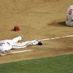 Philadelphia Phillies' Shane Victorino (8) and Arizona Diamondbacks' Conor Jackson lie on the ground after coliding at first base during the eighth inning of a baseball game Wednesday, May 7, 2008 in Phoenix. Jackson left the game. (AP Photo/Matt York)