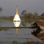 A small temple is seen submerged in a flooded rice field near a house destroyed by last weekend's devastating cyclone near Yangon, Myanmar, Thursday, May 8, 2008. The U.N.'s World Food Program says its first flight carrying aid has landed in Myanmar after the military regime gave clearance to send relief material to cyclone victims. (AP Photo)
