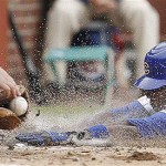 Chicago Cubs' Alfonso Soriano, right, slides into home plate to beat the tag by Arizona Diamondbacks catcher Chris Snyder during the third inning of a baseball game on Saturday, May 10, 2008 in Chicago. (AP Photo/Nam Y. Huh)
