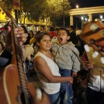 Guadalupe Fernandez, carrying her son Carlitos, listens to music from a mariachi band during Mother's Day celebrations at Plaza Garibaldi in Mexico City, early Saturday, May 10, 2008. (AP Photo/Marco Ugarte)
