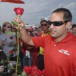 Juan Pablo Montoya gives out rose to race fans in the infield in celebration of Mother's Day, before the NASCAR Dodge Challenger 500 Sprint Cup auto race at Darlington International Raceway in Darlington, S.C., Saturday, May 10, 2008. (AP Photo/Richard Shiro)
