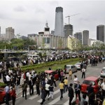 People evacuate office buildings after a 7.5-magnitude earthquake in Beijing Monday, May 12, 2008. A 7.5-magnitude quake struck central China on Monday and was felt as far away as Thailand and Vietnam. Thousands of people evacuated buildings in Beijing, some 900 miles (1,500 kilometers) from the epicenter. The quake struck 57 miles (92 kilometers) northwest of the Sichuan provincial capital of Chengdu at 2:28 p.m. (0628 GMT), the U.S. Geological Survey said on its Web site. It said the 7.5-magnitude quake was centered 6.2 miles (10 kilometers) below the surface. (AP Photo/Oded Balilty)