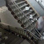A man walks down a staircase full of debris inside a hospital after an earthquake in Chengdu of southwest China's Sichuan province, Monday, May 12, 2008. Thousands of soldiers and police were dispatched to central China after a massive earthquake Monday killed at least 107 people and buried nearly 900 schoolchildren. (AP Photo/Color China Photo)
