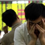An investor reacts as he looks at the stock price monitor at a private security company Monday, May 12, 2008 in Shanghai, China. Chinese stocks rose Monday, rebounding from early losses on gains in banking shares. But the advance was capped by worries over inflation and over potential damage from a severe earthquake that hit central China's Sichuan province. (AP Photo)