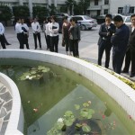 Hotel staff watch the movement of water in a fish pond after the hotel was evacuated during an earthquake in Fuyang, in China's Anhui province Monday May 12, 2008. A powerful, magnitude 7.8 earthquake struck mountainous central China on Monday, killing five people when two primary schools and a water tower collapsed, state media reported. (AP Photo/Greg Baker)