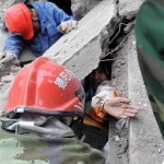 In this photo released by China's Xinhua news agency, rescuers try to help a stranded student out of the debris at Wudu Primary School at Hanwang town in Mianzhu city, southwest China's Sichuan Province, Tuesday, May 13, 2008. China state media says that 10,000 people "remain buried" in rubble in Mianzhu near the epicenter of Monday's 7.9-magnitude earthquake that struck the country. (AP Photo/Xinhua, He Junchang)