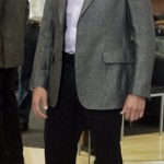 Eddie Ginez models a light-colored sport coat and dark slacks, which direct attention upward rather than toward his feet, all of which make the 5'7" Ginez appear taller, at Jimmy Au's For Men 5'8" And Under in Beverly Hills, Calif., Wednesday, April 30, 2008. Finding a suit that fits is getting easier for the shorter man. National chains still don't offer many options, but legions of shorter men in the country are increasingly discovering specialty stores just for them. (AP Photo/Reed Saxon)
