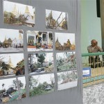 A Buddhist man prays beside pictures of cyclone-damaged areas at the Schwedagon Pagoda in Yangon, Myanmar, Wednesday, May 14, 2008. (AP Photo)