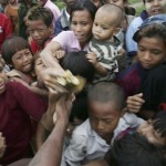 Myanmar cyclone survivors grab a free banana from a local donor on the outskirts of Yangon, Myanmar, on Wednesday May 14, 2008. (AP Photo)