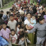 Myanmar cyclone survivors line up to receive food and water from local donors on the outskirts of Yangon, Myanmar, on Wednesday May 14, 2008. (AP Photo)