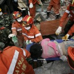 Rescuers carry a female survivor out of a school damaged following Monday's powerful 7.9 magnitude earthquake in Hanwang town in Sichuan province, China, Wednesday, May 14, 2008. (AP Photo/Andy Wong)
