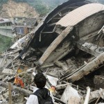 A concrete building destroyed by a devastating earthquake in hard-hit Beichuan county, Mianyang city, Sichuan province, China, is seen Thursday afternoon, May 15, 2008. China warned the death toll from this week's earthquake could soar to 50,000, while the government issued a rare public appeal Thursday for rescue equipment as it struggled to cope with the disaster. (AP Photo/Kyodo News, Takanori Sekine)