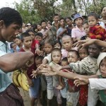 Myanmar children reach their hands out to receive a free banana from a local donor on the outskirts of Yangon, Myanmar, on Wednesday May 14, 2008. (AP Photo)