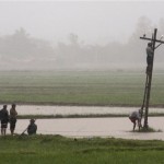 Myanmar workers repair a power line during a heavy rain storm on the outskirts of Yangon, Myanmar, Thursday, May 15, 2008. Heavy rains and another potentially powerful storm headed toward Myanmar's cyclone-devastated delta Thursday, as the U.N. warned that inadequate relief efforts could lead to a second wave of deaths among the estimated 2 million survivors. (AP Photo)