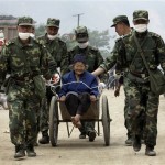 Chinese soldiers uses a trolley to transfer an elderly woman, who survived Monday's 7.8 magnitude earthquake in Beichuan county, Sichuan province, China, Friday, May 16, 2008. A strong aftershock sparked landslides Friday near the epicenter of this week's powerful earthquake, again cutting off ravaged areas of central China. (AP Photo/Andy Wong)
