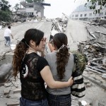 Two women cry as they wait for news of relatives by a collapsed buildings following Monday's 7.8 magnitude earthquake in Beichuan county, Sichuan province, China, Friday, May 16, 2008. A strong aftershock sparked landslides Friday near the epicenter of this week's powerful earthquake, again cutting off ravaged areas of central China. (AP Photo/Andy Wong)
