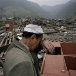 An earthquake survivor stands next to the rubble of his collapsed house in Yinghua town of southwest China's Sichuan province, Friday, May 16, 2008. A strong aftershock sparked landslides Friday near the epicenter of this week's powerful earthquake, again cutting off ravaged areas of central China. (AP Photo/Oded Balilty)