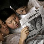 Earthquake survivors gather to read a newspaper about the recent earthquake collapsed school in BeiChuan, while they rest at a temporary shelter in Mianyang, Southwestern Sichuan province, China, Monday, May 19, 2008. China stood still Monday, mourning for tens of thousands of earthquake victims, while the government appealed for more international aid to cope with the country's deadliest natural disaster in a generation. (AP Photo/Andy Wong)
