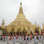 Survivors of Cyclone Nargis walk with flags at Schewadagon Pagoda as they observe Buddha's birthday at the capital of Yangon, Myanmar on Monday May 19, 2008. The event is celebrated by the ceremonial watering of Bo trees, the sacred Banyan tree under which Buddha attained enlightenment. (AP Photo)