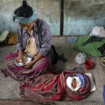 A homeless Myanmar woman eats rice beside her one day old baby at a temporary shelter on the outskirts of Yangon, Myanmar, Tuesday, May 20, 2008. (AP Photo)