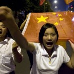 Chinese youths express encouragement towards China and the victims of last week's earthquake during a street march by hundreds of residents in Chengdu, southwestern China's Sichuan province, Tuesday, May 20, 2008. Flags in the country remained at half-staff and entertainment events canceled on the second day of a three-day national mourning period declared by the Chinese government, an unprecedented gesture normally reserved for dead state leaders. (AP Photo/Ng Han Guan)