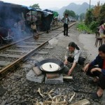Residents cook a meal at a temporary shelter beside a railway track at Yinghua, in Shifang county, in China's southwest Sichuan province Tuesday May 20, 2008. China said it was struggling to find shelter for many of the 5 million people whose homes were destroyed in last week's earthquake, while the region remained jittery Tuesday over warnings of aftershocks. (AP Photo/Greg Baker)