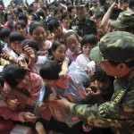 Soldiers deliver schoolbags to pupils at the new Zundao Primary School in Mianzhu of south China's Guangdong province Wednesday, May 21, 2008. China's first aseismic primary school started classes Wednesday. (AP Photo/Color China Photo)