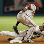 Arizona Diamondbacks second baseman Orlando Hudson, foreground, tags out Florida Marlins' Luis Gonzalez on a stolen-base attempt in the seventh inning of a baseball game in Miami, Wednesday, May 21, 2008. The Marlins won 3-1. (AP Photo/Alan Diaz)