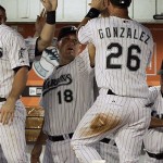 Florida Marlins' Luis Gonzalez (26) is congratulated by teammate Wes Helms (18) after Gonzalez scored on a sacrifice bunt by Matt Treanor against the Arizona Diamondbacks in the fifth inning of a baseball game in Miami, Wednesday, May 21, 2008. The Marlins won 3-1. (AP Photo/Alan Diaz)