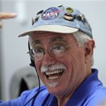 Peter Smith, principal investigator, University of Arizona, points to his hat at the Jet Propulsion Laboratory in Pasadena, Calif. after they received word that NASA's Phoenix Mars Lander landed safely on Mars near its north pole, Sunday, May 25, 2008. (AP Photo/Lawrence K. Ho/Pool)