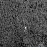 This photo provided by NASA/JPL-Caltech/University of Arizona shows NASA's Phoenix Mars Lander suspended from its parachute as it lands on Mars on Sunday May 25, 2008 as seen by a telescopic camera in orbit. (AP Photo/NASA/JPL-Caltech/University of Arizona)