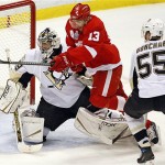 Detroit Red Wings' Pavel Datsyuk (13) jumps between Pittsburgh Penguins goalie Marc-Andre Fleury and Sergei Gonchar, from Russia, during first period of Game 5 of the NHL Stanley Cup Finals Monday, June 2, 2008 in Detroit. (AP Photo/The Canadian Press, Frank Gunn)