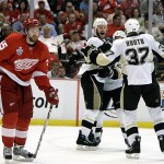 Detroit Red Wings defenseman Niklas Kronwall (55) of Sweden skates by Pittsburgh Penguins forward Adam Hall, center left, as he celebrates with teammates after scoring a goal during first period hockey action in Game 5 of the Stanley Cup finals in Detroit, Monday, June 2, 2008. (AP Photo/Gene Puskar)